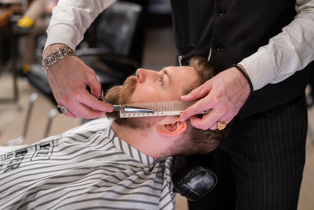 Grooming and Lifestyle Tips That’ll Take Years Off Your Looks 1 a man getting his hair brushed