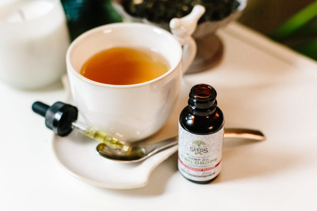 Making CBD a Part of Your Health Routine 1 a cup of tea and a bottle