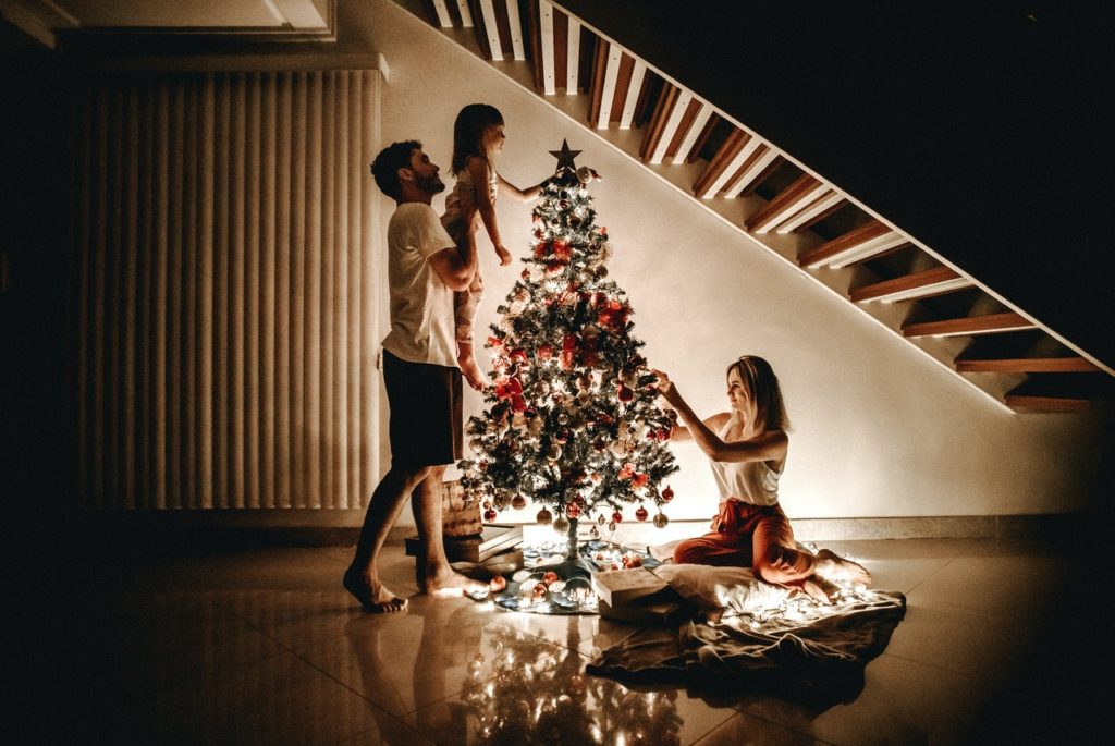 How to Decorate Your House for Christmas 1 a group of people dancing around a christmas tree