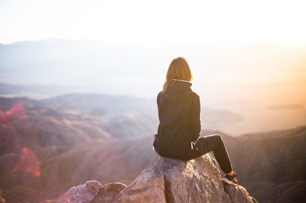 a person sitting on a rock