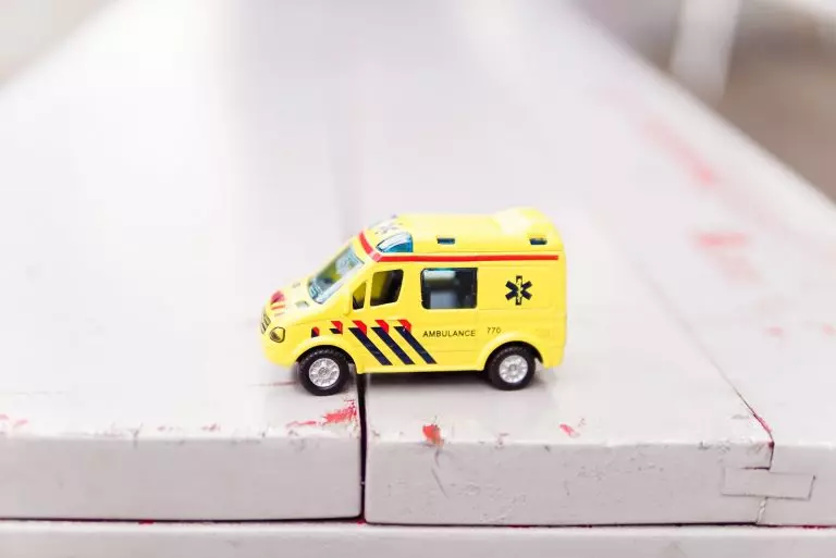 a toy car on a railing