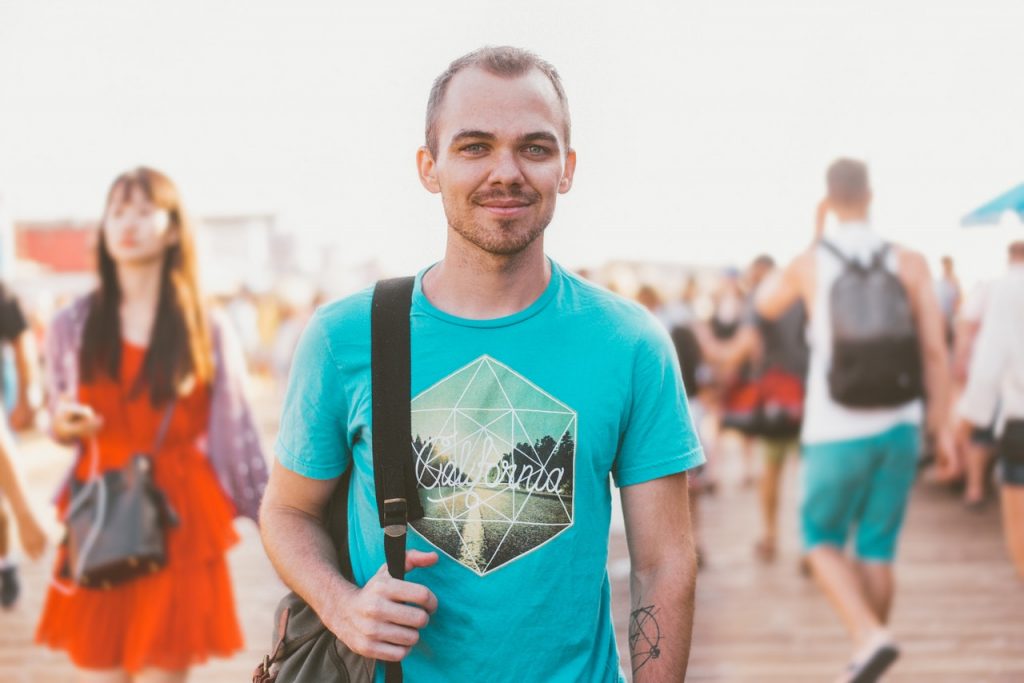 a person with a backpack on a boardwalk