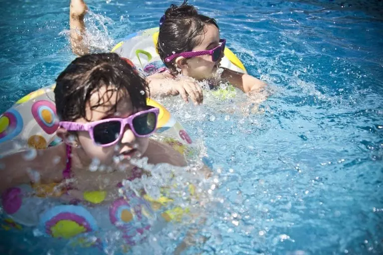 two kids swimming in water