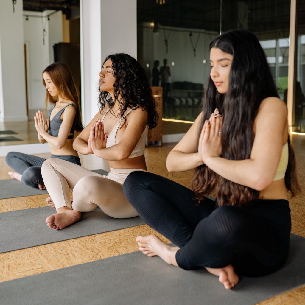 a group of women sitting on the floor