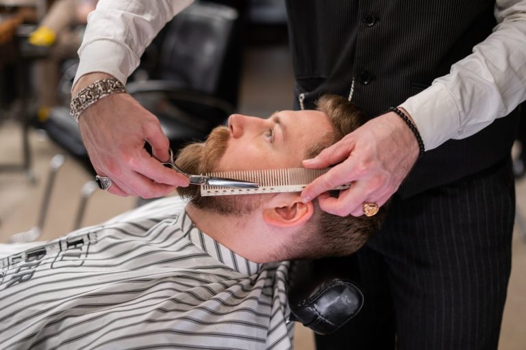 a man getting his hair brushed