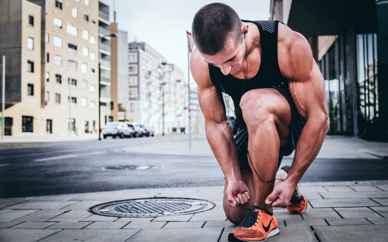 a person squatting on a street