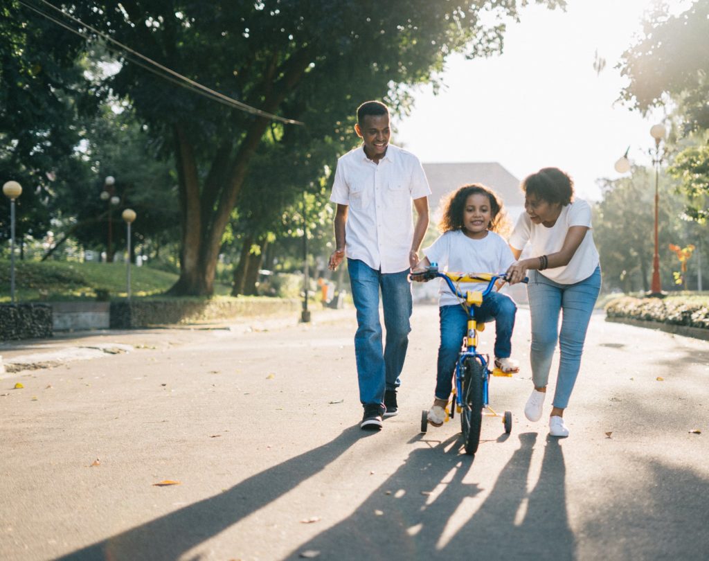 a person and a child riding bikes