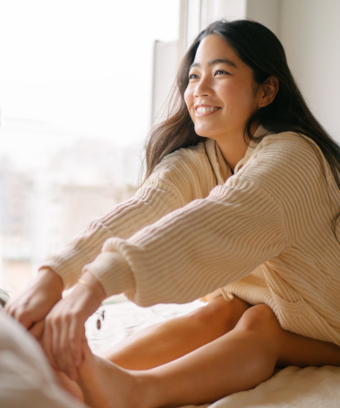 a woman sitting on a bed