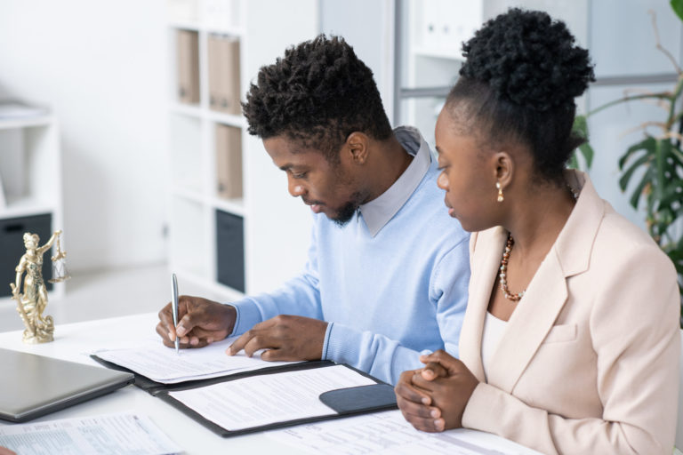 a man and a woman looking at a computer screen